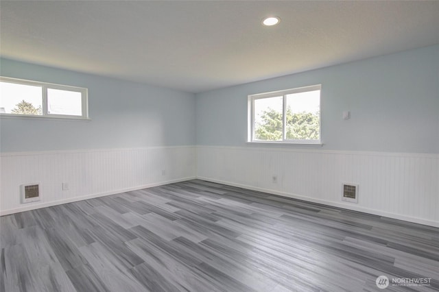 393 Canal Dr SE, Ocean Shores, WA 98569 - unfurnished room with a wainscoted wall, wood finished floors, and recessed lighting