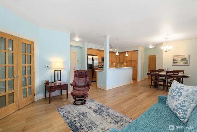 1501 Tacoma Ave S Unit 212, Tacoma, WA 98402 - living room featuring ornamental molding, light wood-style floors, and a chandelier