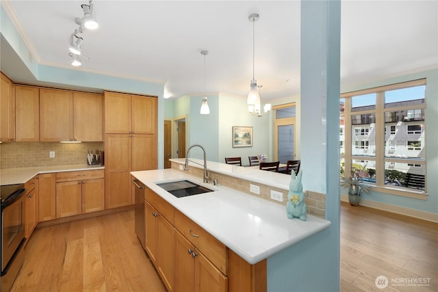 1501 Tacoma Ave S Unit 212, Tacoma, WA 98402 - kitchen with a sink, stainless steel appliances, decorative backsplash, light wood-style floors, and light countertops
