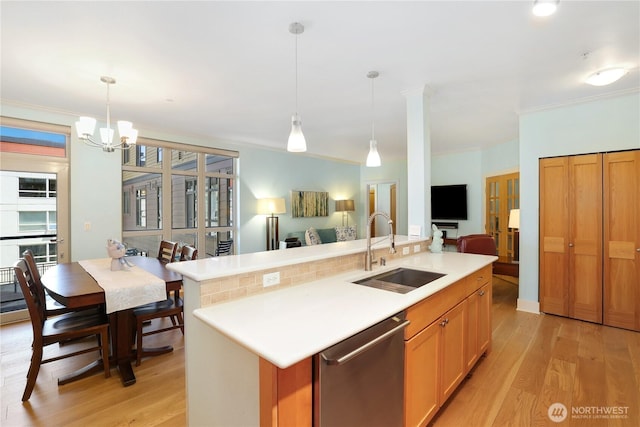 1501 Tacoma Ave S Unit 212, Tacoma, WA 98402 - kitchen with a sink, stainless steel dishwasher, light wood-type flooring, open floor plan, and crown molding