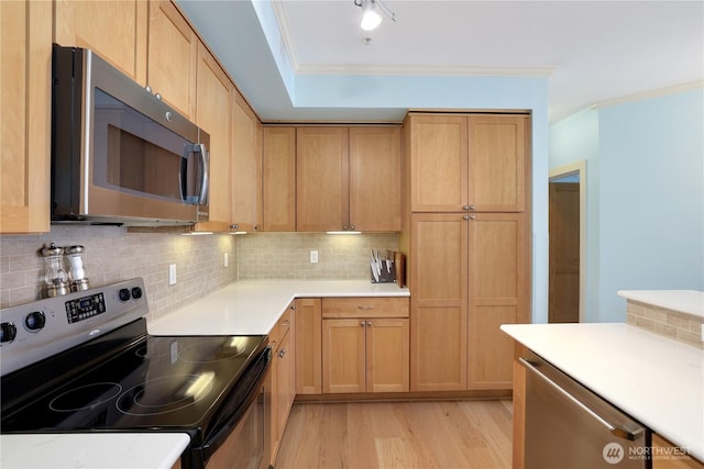 1501 Tacoma Ave S Unit 212, Tacoma, WA 98402 - kitchen with stainless steel appliances, crown molding, light wood-style flooring, backsplash, and light countertops