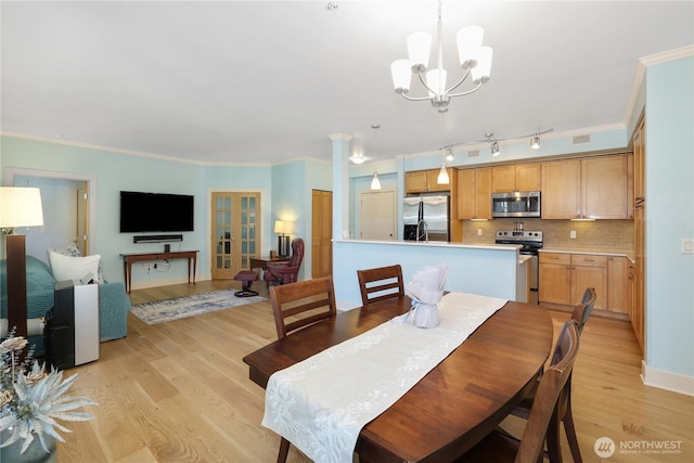 1501 Tacoma Ave S Unit 212, Tacoma, WA 98402 - dining room with light wood finished floors, a chandelier, ornamental molding, and baseboards