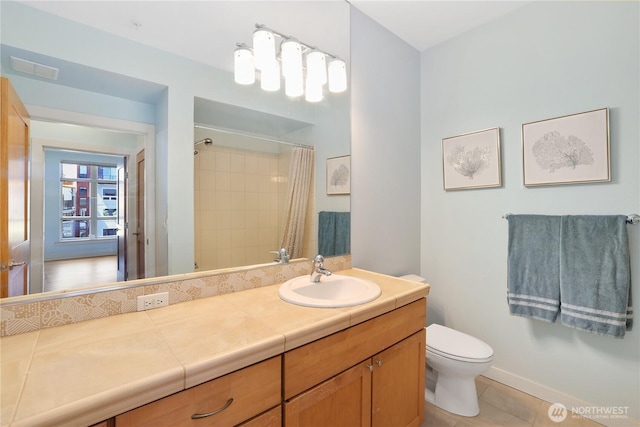 1501 Tacoma Ave S Unit 212, Tacoma, WA 98402 - bathroom featuring toilet, vanity, a shower with curtain, tile patterned flooring, and baseboards