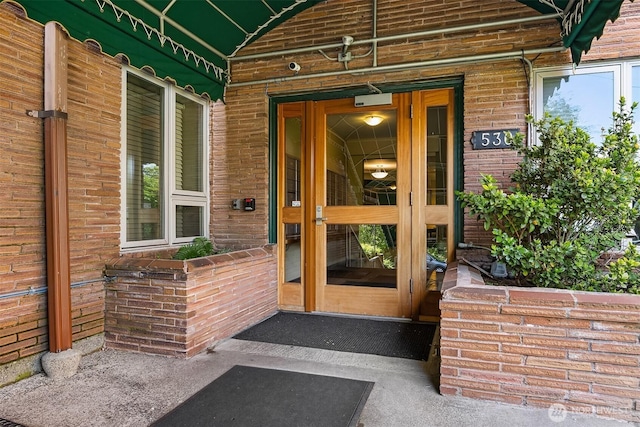 530 W Olympic Pl Unit 406, Seattle, WA 98119 - view of exterior entry featuring brick siding