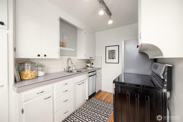 530 W Olympic Pl Unit 406, Seattle, WA 98119 - kitchen with a sink, appliances with stainless steel finishes, open shelves, light countertops, and tasteful backsplash