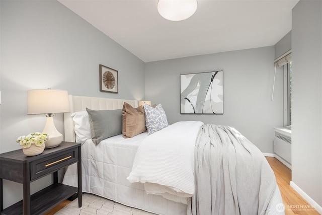 530 W Olympic Pl Unit 406, Seattle, WA 98119 - bedroom with radiator and wood finished floors