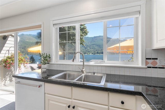 562 W Lake Samish Dr, Bellingham, WA 98229 - kitchen featuring a sink, dark countertops, white cabinetry, and a mountain view