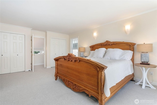 562 W Lake Samish Dr, Bellingham, WA 98229 - bedroom featuring two closets, light carpet, crown molding, and baseboards