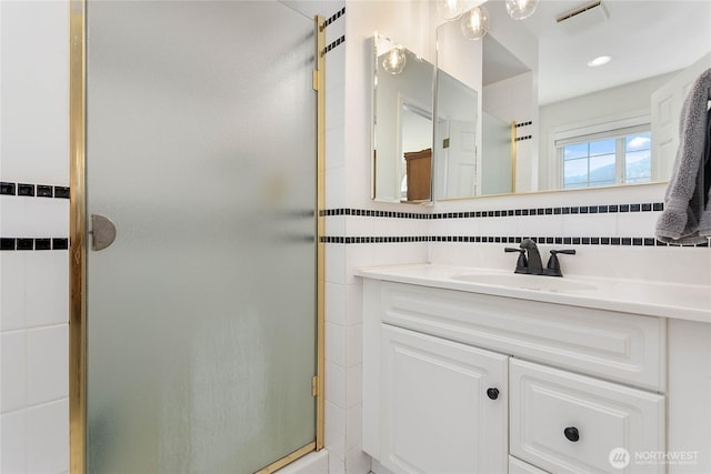 562 W Lake Samish Dr, Bellingham, WA 98229 - full bathroom featuring vanity, a shower stall, tile walls, and backsplash