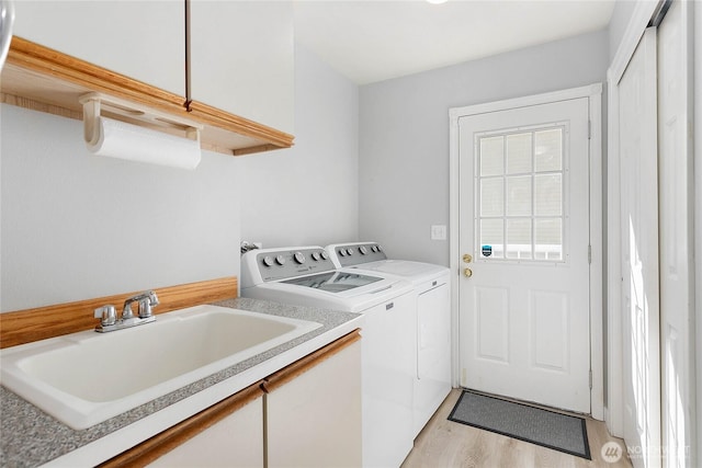 562 W Lake Samish Dr, Bellingham, WA 98229 - laundry area with washing machine and dryer, light wood-type flooring, and cabinet space
