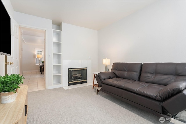 562 W Lake Samish Dr, Bellingham, WA 98229 - living area featuring light colored carpet, baseboards, a fireplace, light tile patterned floors, and built in shelves