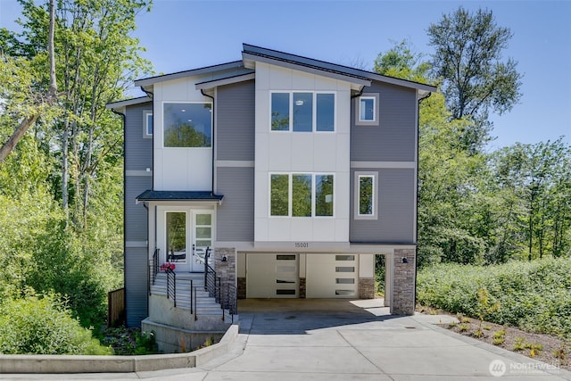 15001 NE 8th St, Bellevue, WA 98007 - contemporary home featuring driveway, an attached garage, board and batten siding, and stone siding