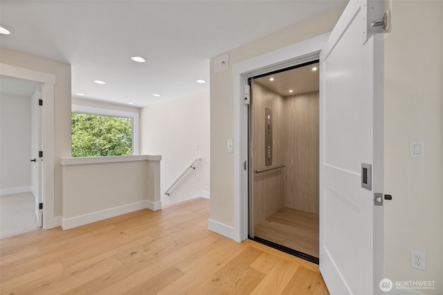 15001 NE 8th St, Bellevue, WA 98007 - corridor featuring elevator, an upstairs landing, wood finished floors, recessed lighting, and baseboards