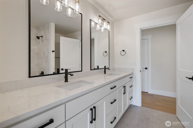 15001 NE 8th St, Bellevue, WA 98007 - bathroom with double vanity, a tile shower, and baseboards