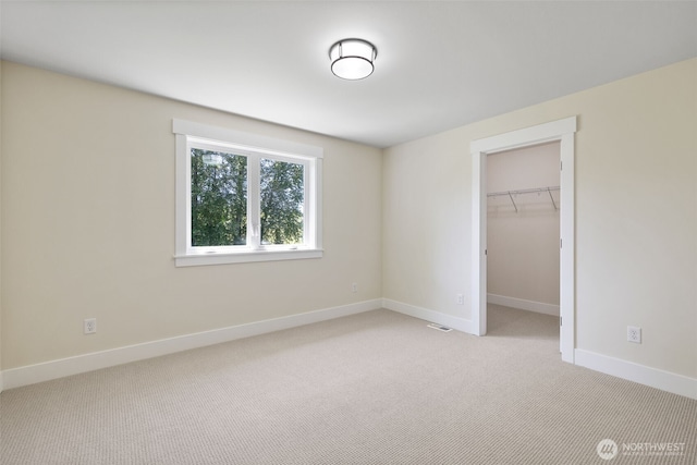 15001 NE 8th St, Bellevue, WA 98007 - unfurnished bedroom featuring light carpet, baseboards, a spacious closet, and a closet