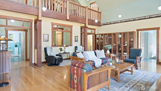 10539 N Madison Ave NE, Bainbridge Island, WA 98110 - living room with a high ceiling, wood finished floors, and baseboards