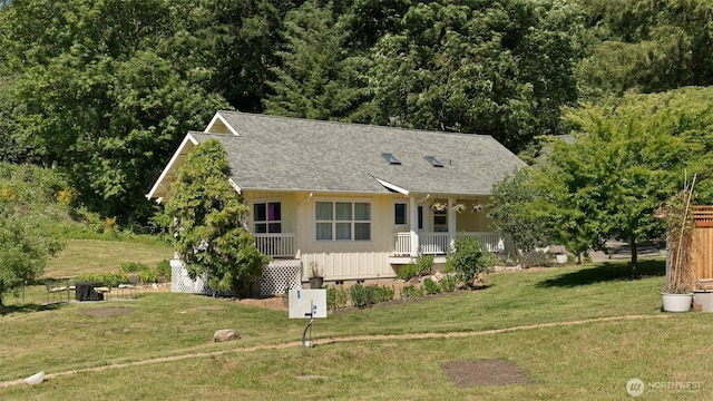 10539 N Madison Ave NE, Bainbridge Island, WA 98110 - view of front of home featuring covered porch, board and batten siding, a front lawn, and roof with shingles