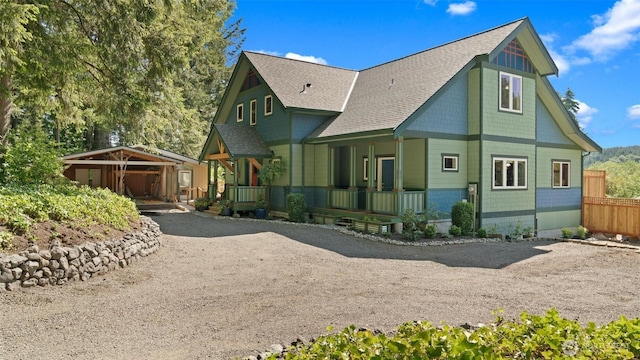 10539 N Madison Ave NE, Bainbridge Island, WA 98110 - back of property with a shingled roof, a porch, and dirt driveway