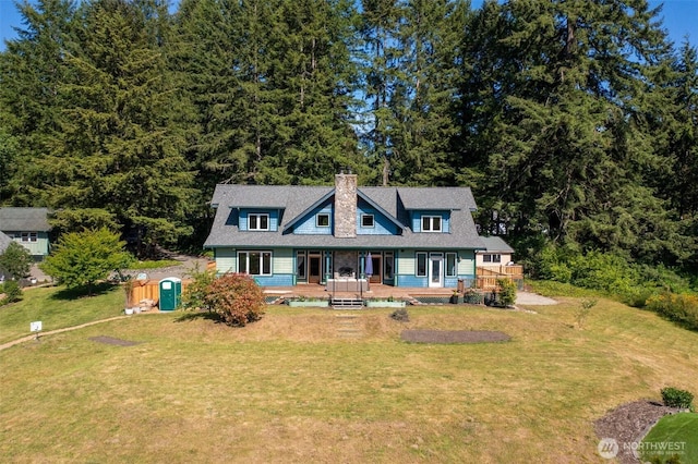10539 N Madison Ave NE, Bainbridge Island, WA 98110 - view of front of home featuring a chimney, a front yard, and a wooden deck