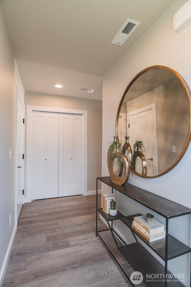 123 E 9th Ave Unit 67, Moses Lake, WA 98837 - hallway with recessed lighting, wood finished floors, baseboards, and a wall mounted air conditioner