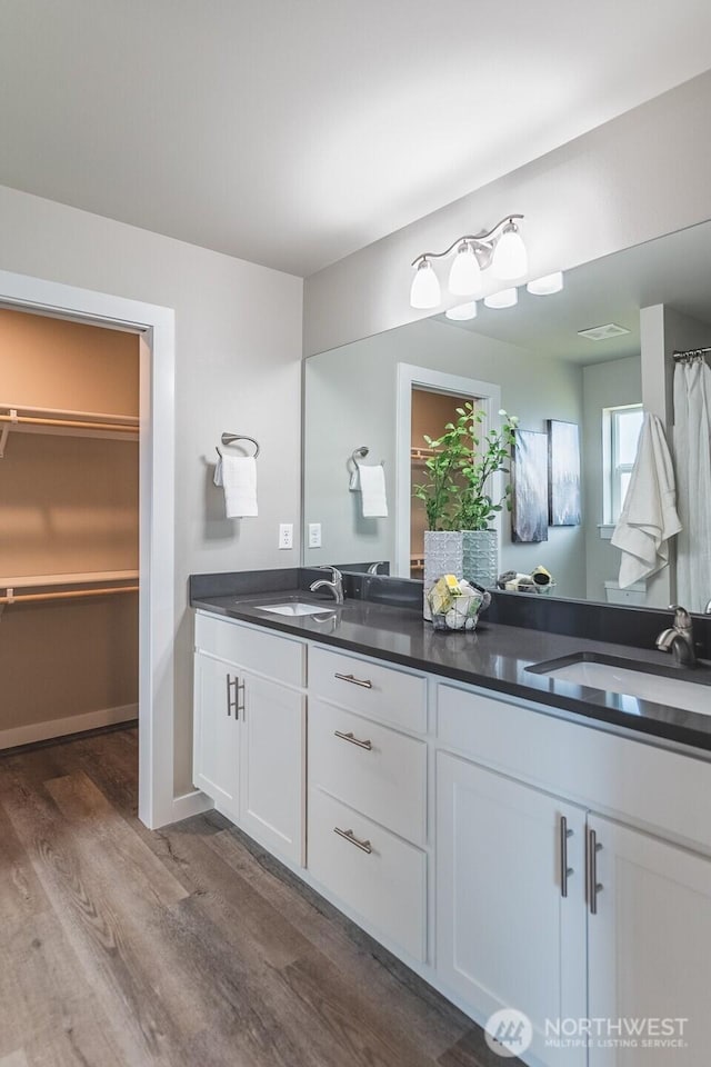 123 E 9th Ave Unit 67, Moses Lake, WA 98837 - full bath featuring wood finished floors, double vanity, and a spacious closet