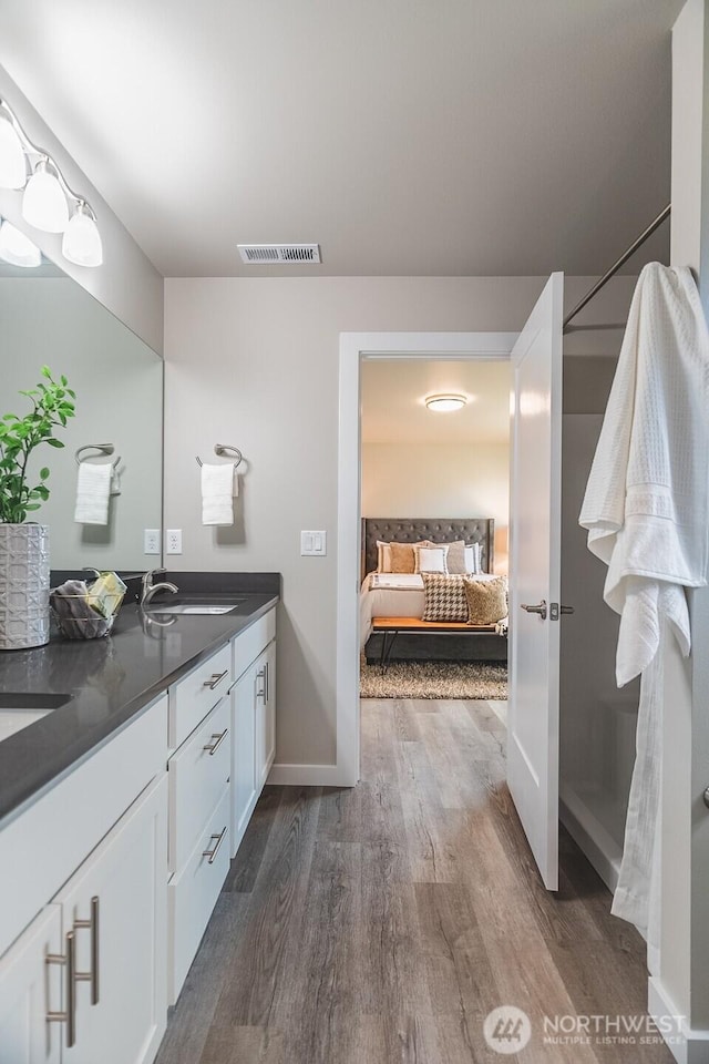 123 E 9th Ave Unit 67, Moses Lake, WA 98837 - ensuite bathroom with double vanity, wood finished floors, and baseboards