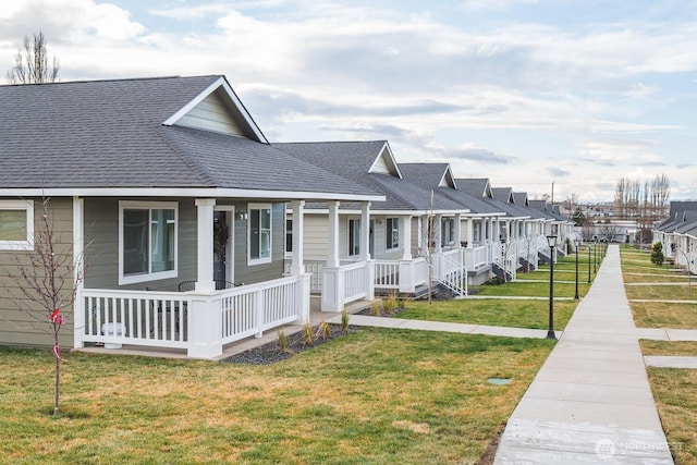 123 E 9th Ave Unit 67, Moses Lake, WA 98837 - view of front of house with covered porch, roof with shingles, a residential view, and a front yard