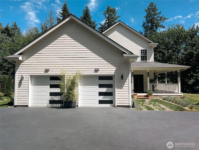 10920 Chaucer St SE, Olympia, WA 98501 - view of front of house with asphalt driveway, covered porch, and a garage