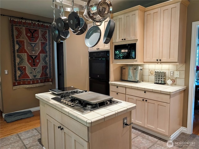 10920 Chaucer St SE, Olympia, WA 98501 - kitchen featuring tile counters, stainless steel gas stovetop, decorative backsplash, and a kitchen island