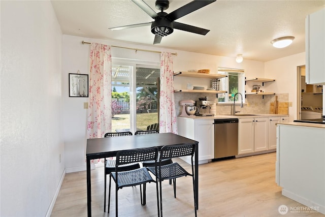 5601 Mount Tahoma Ct SE, Lacey, WA 98503 - kitchen with dishwasher, a sink, light wood-style floors, and backsplash