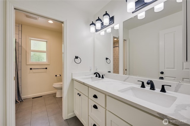 16710 Snohomish Ave, Snohomish, WA 98296 - bathroom featuring toilet, baseboards, double vanity, and tile patterned floors