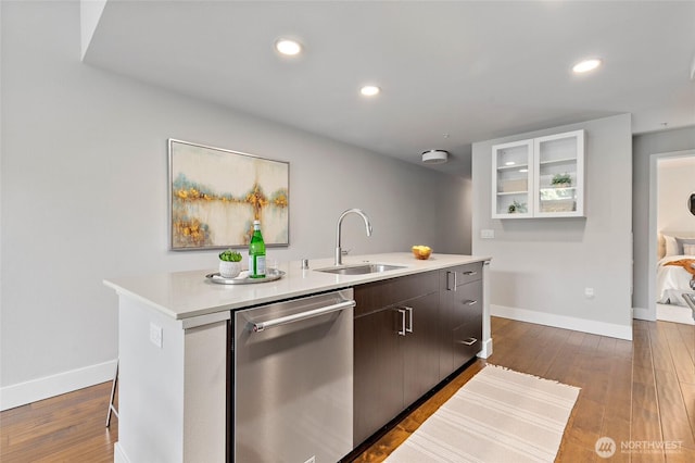 50 Pine St Unit 420, Edmonds, WA 98020 - kitchen with dishwasher, a sink, a kitchen island with sink, light countertops, and baseboards