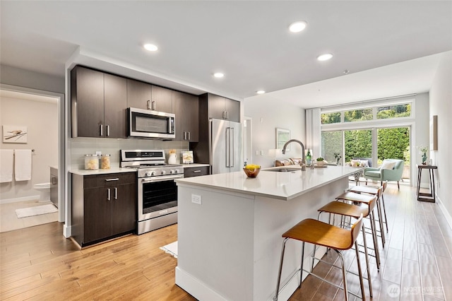 50 Pine St Unit 420, Edmonds, WA 98020 - kitchen featuring appliances with stainless steel finishes, a breakfast bar, a sink, light countertops, and recessed lighting