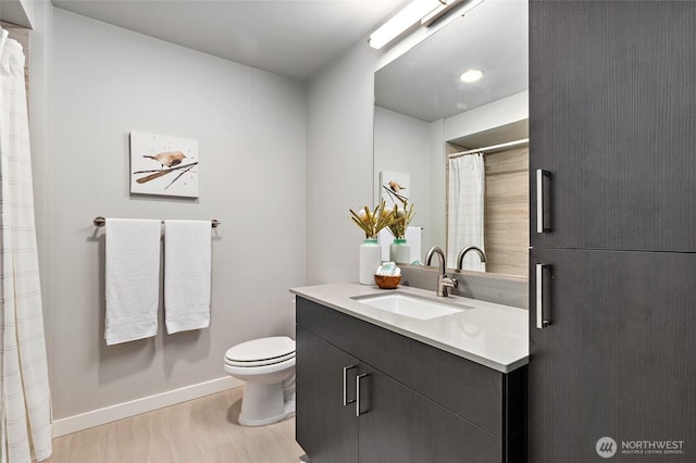 50 Pine St Unit 420, Edmonds, WA 98020 - full bathroom with toilet, vanity, baseboards, and wood finished floors