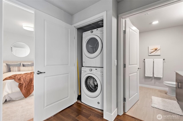 50 Pine St Unit 420, Edmonds, WA 98020 - washroom featuring estacked washer and dryer and dark wood finished floors