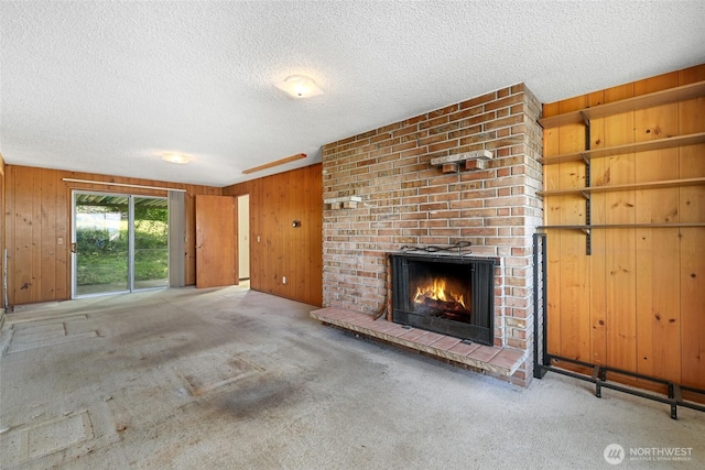 3115 43rd Ave NE, Tacoma, WA 98422 - unfurnished living room featuring wooden walls, carpet, a textured ceiling, and a brick fireplace