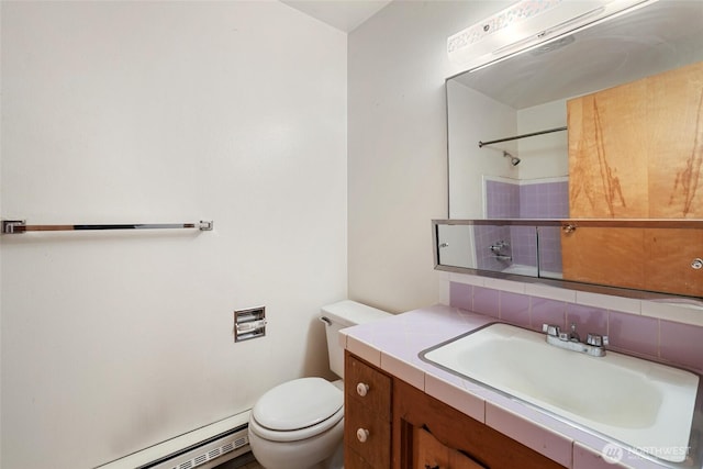 3115 43rd Ave NE, Tacoma, WA 98422 - bathroom with a baseboard heating unit, toilet, vanity, backsplash, and a shower