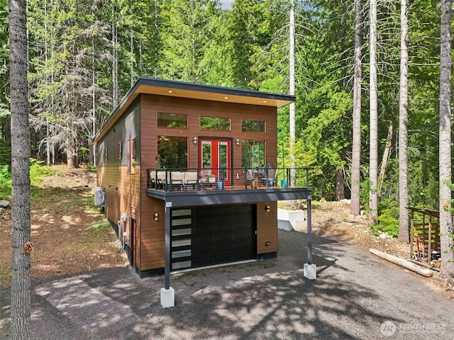 3271 Via Kachess Rd, Easton, WA 98925 - view of front of home with a view of trees, asphalt driveway, french doors, and a garage