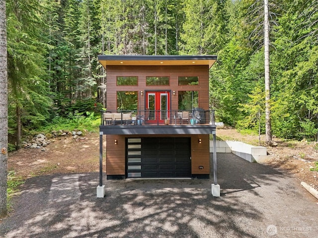 3271 Via Kachess Rd, Easton, WA 98925 - view of front of home with a forest view, driveway, french doors, and a balcony