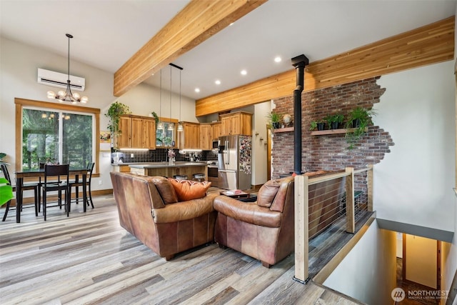 3271 Via Kachess Rd, Easton, WA 98925 - living room featuring light wood-style flooring, a wall mounted air conditioner, a chandelier, beam ceiling, and recessed lighting