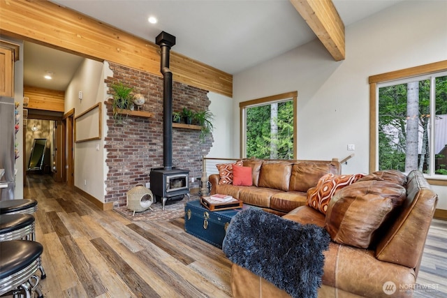3271 Via Kachess Rd, Easton, WA 98925 - living room with a wood stove, wood finished floors, beam ceiling, and recessed lighting