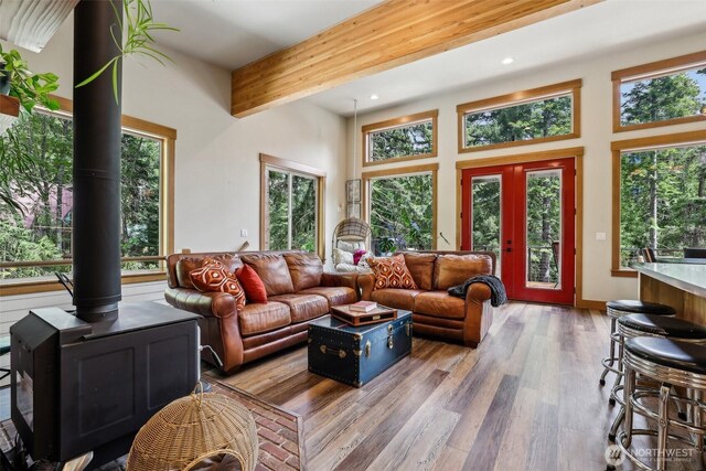 3271 Via Kachess Rd, Easton, WA 98925 - living room featuring wood finished floors, a wood stove, a towering ceiling, beamed ceiling, and recessed lighting