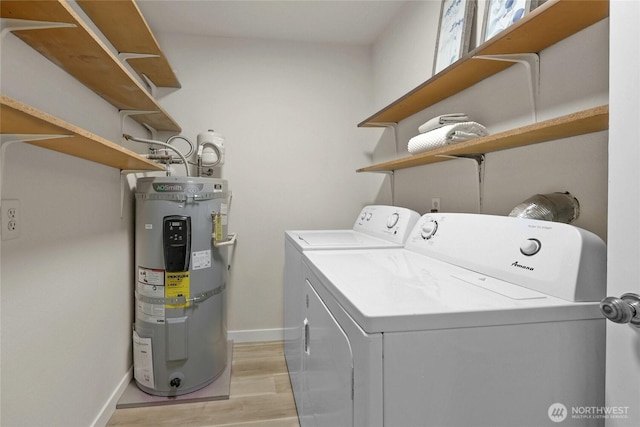 12707 NE 130th Ct Unit B102, Kirkland, WA 98034 - washroom with strapped water heater, washing machine and clothes dryer, light wood finished floors, and baseboards