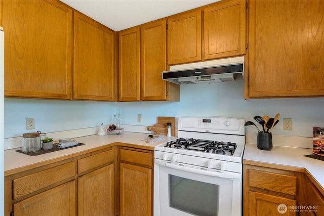 3861 Gala Loop, Bellingham, WA 98226 - kitchen featuring gas range gas stove, under cabinet range hood, light countertops, and brown cabinets