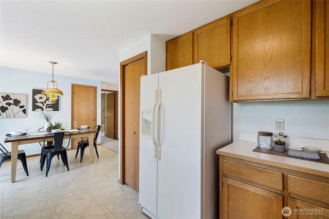 3861 Gala Loop, Bellingham, WA 98226 - kitchen featuring white refrigerator with ice dispenser, light floors, brown cabinetry, decorative light fixtures, and light countertops