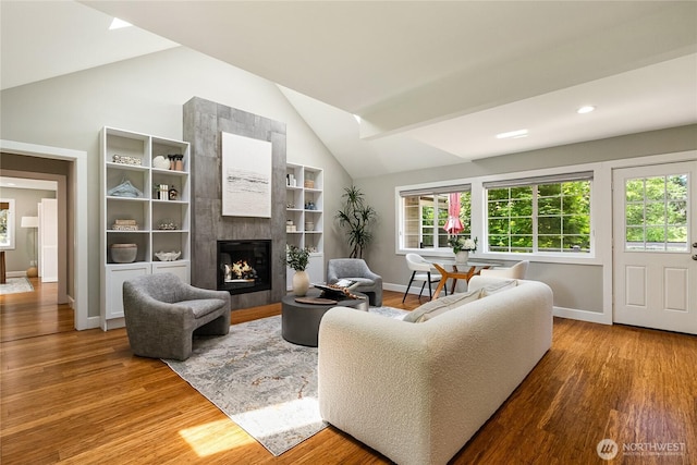 761 Chuckanut Dr, Bellingham, WA 98229 - living room featuring wood finished floors, healthy amount of natural light, a fireplace, high vaulted ceiling, and recessed lighting