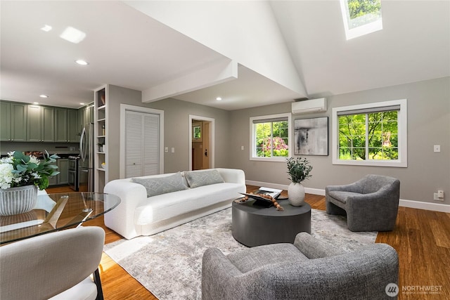 761 Chuckanut Dr, Bellingham, WA 98229 - living area with an AC wall unit, wood finished floors, baseboards, recessed lighting, and a skylight