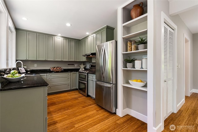 761 Chuckanut Dr, Bellingham, WA 98229 - kitchen featuring appliances with stainless steel finishes, open shelves, a sink, wood finished floors, and dark stone counters