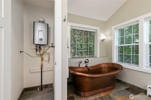 761 Chuckanut Dr, Bellingham, WA 98229 - bathroom with tankless water heater, baseboards, a freestanding tub, lofted ceiling, and a baseboard heating unit