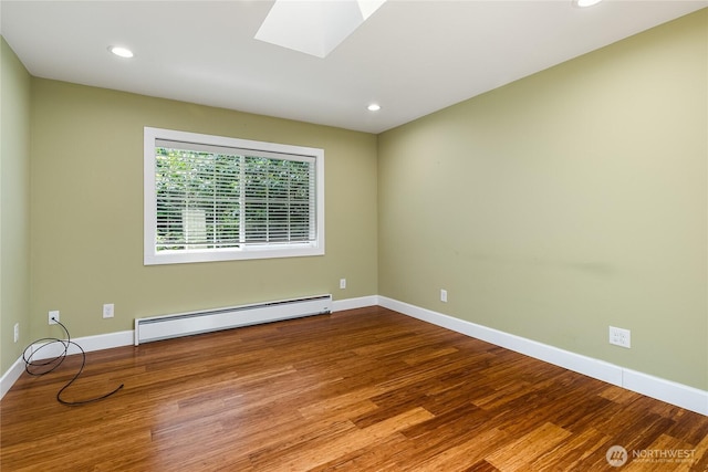 761 Chuckanut Dr, Bellingham, WA 98229 - spare room featuring baseboard heating, wood finished floors, a skylight, baseboards, and recessed lighting